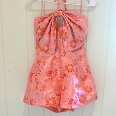 Nwt, Never Worn, Size S Fit: The Kira Romper Fits True To Size. Length: Mid Thigh Length Bust: Relaxed Fit- Smocking Allows For Stretch. Waist: Fitted. Fabric: Fabric Contains No Stretch. Material: 100% Polyester Sleeveless Pink Party Jumpsuits And Rompers, Feminine Sleeveless Party Jumpsuits And Rompers, Pink Feminine Jumpsuits And Rompers For Summer, Feminine Pink Jumpsuits And Rompers For Summer, Chic Pink Halter Neck Jumpsuit, Pink Halter Neck Jumpsuit For Party, Pink Summer Halter Neck Jumpsuit, Pink Fitted Halter Neck Jumpsuit Or Romper, Pink Halter Neck Jumpsuit For Summer