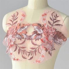 the back of a mannequin with flowers and leaves on it's chest