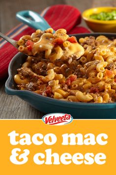 a pan filled with taco macaroni and cheese on top of a wooden table