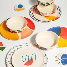 colorful plates and bowls on a white table