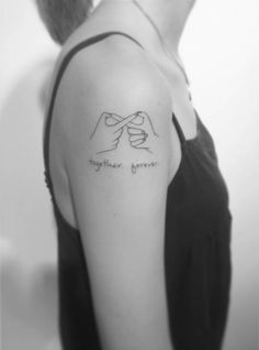 a woman wearing a black tank top and holding hands with the words together forever on her arm