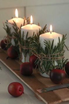 some candles are sitting on a cutting board