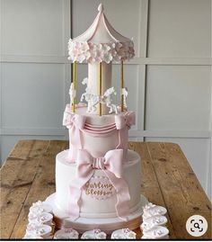 a three tiered cake with pink and white decorations