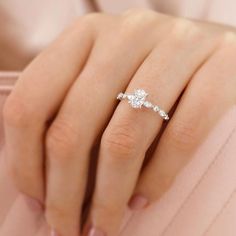 a woman's hand with a diamond ring on it