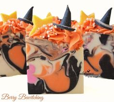 three halloween themed soaps with orange, black and white frosting on them are decorated with witches hats