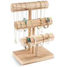 a wooden jewelry stand with rings and bracelets on it's display rack,