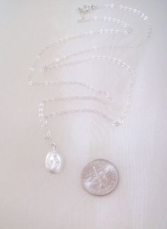 "Similar items: ALLDANAE.etsy.com Please read my shop policies before ordering: https://www.etsy.com/shop/AllDanae#policies A Miraculous Medal necklace in all .925 sterling silver materials. The tiny pendant is understated and lightweight, yet sturdy. It measures approximately 12X9mm (about 1/2 inch X 5/16 inch). It shows an image of the Virgin Mary crowned with a halo. The tiny letters around the circumference of the pendant read: \"O Mary conceived without sin pray for us who have recourse to Silver Sterling Oval Charm Necklaces, Silver Oval Sterling Silver Charm Necklace, Oval Silver Sterling Silver Charm Necklaces, Silver Sterling Silver Charm Necklace With Oval Pendant, Silver Sterling Silver Oval Pendant Charm Necklaces, Silver Oval Pendant Charm Necklace In Sterling Silver, Sterling Silver Charm Necklace With Oval Pendant, Simple Engraved Silver Jewelry, Minimalist Sterling Silver Nickel-free Charm Necklaces