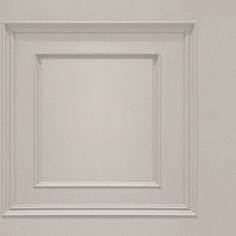 an empty white square frame hanging on the wall