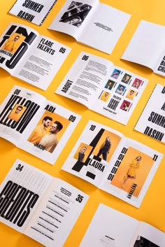 an assortment of brochures are displayed on a yellow surface with black and white images