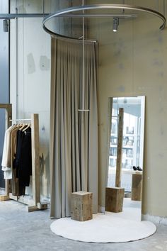 the inside of a clothing store with clothes on display