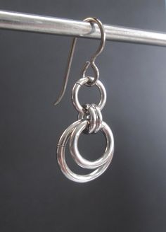 These earrings are made with non-tarnish stainless steel jump rings, and hypoallergenic titanium ear wires. They have an urban minimalist feel to them and can be worn on anyone with anything! They are 1 1/4 inches (3.2 cm) long and 1/2 an inch (1.3 cm) wide. I have a larger version of these earrings listed here: https://www.etsy.com/listing/608057584/stainless-steel-earrings-hypoallergenic?ref=shop_home_active_1 I have more stainless steel earrings here: https://www.etsy.com/shop/BlackCatLinks?r Hypoallergenic Round Surgical Steel Earrings, Hypoallergenic Small Hoop Stainless Steel Earrings, Hypoallergenic Small Hoop Earrings In Stainless Steel, Nickel-free Round Stainless Steel Earrings, Nickel-free Stainless Steel Round Earrings, Hypoallergenic Round Stainless Steel Earrings, Hypoallergenic Stainless Steel Round Earrings, Nickel-free Minimalist Surgical Steel Earrings, Nickel-free Small Hoop Earrings In Surgical Steel