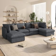 a living room with a large sectional couch and coffee table in it's center