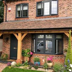 a brick house with black doors and windows