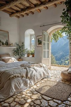 a bedroom with an arched doorway leading to the outside