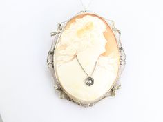 The frame of this vintage piece is 14 karat white gold work with a wonderful, shining patina. Exquisitely carved from a richly shaded conch shell, this lady is beautifully portrayed, with wonderful expression and gorgeous floral accents. A diamond necklace around her throat is set with a single sparkling diamond! This pendant does not come with the chain shown. Please feel free to contact us, we will help you find the perfect chain for your style and budget! Metal: 14K White Gold Gem: Shell Came Cameo Ring, Vintage Cameo, Sparkling Diamond, Cameo Brooch, Cameo Pendant, Gold Work, Brooch Vintage, Conch Shell, Art Deco Diamond