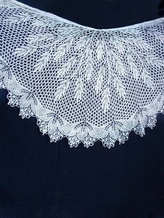 Elegant and timeless, this hand knit lace shawl in delicate white is the perfect accessory for a wedding or any other special occasion. This shawl wrap has intricate floral patterns that add a touch of romance and sophistication. Handmade from soft and cozy wool, it provides warmth and comfort while exuding a sense of grace and beauty. If  you're looking for a thoughtful wool anniversary gift for wife or a stunning bridal shawl to complement your wedding ensemble, white shawl is sure to make a l Handmade White Lace Shawl, Handmade Lace Shawl In White, Hand Knitted White Shawl For Wedding, White Hand Knitted Shawl For Wedding, Elegant White Crochet Lace Shawl, Elegant White Shawl With Crochet Lace, Handmade White Shawl As Gift, White Crochet Lace Shawl, White Lace Shawl