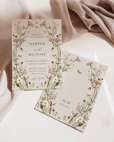 two wedding cards with floral designs on them