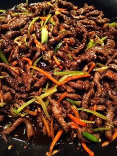 beef and carrot stir fry in a wok