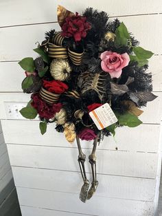 Add some spooky charm to your Halloween decorations with this Ashland Skeleton Wreath. Laced with gold sequin glitter pumpkins and florals, this wreath is perfect for adding a touch of glamour and terror to your home. The wreath features a large skeleton w/legs dangling below the wreath design that will add a stylish and eerie touch to your front door, wall, or mantel. Apothecary Skull Christmas Wreath, Goth Halloween Wreath, Skull Wreaths For Front Door, Skull And Rose Wreath, Skeleton Frame Wreath, Skeleton Wreath, Glitter Pumpkins, Goth Home, Goth Home Decor