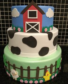 a three tiered cake with a farm scene on it