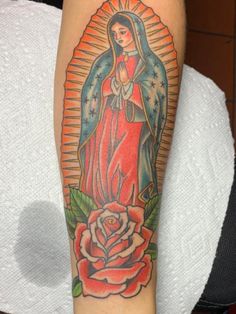 a woman's arm with a tattoo on it and a rose in the center