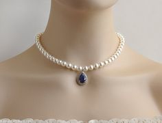 This is a beautiful and elegant classic bridal pearl necklace Made of: - 8mm Swarovski crystal white pearls; - rhodium plated over brass clasp and an extension chain; - 14x23mm blue sapphire Cubic Zirconia teardrop pendant Its length is 16 inches + 2 inches extension chain. Matching Luxury Blue Pearl Drop Necklace, Elegant Drop Pearl Necklace For Wedding, Elegant Blue Pearl Necklace For Formal Occasions, Formal Blue Pearl Drop Necklace, Formal Pear-shaped Pearl Drop Necklace, Elegant Pear-shaped Pearl Drop Necklace, Elegant Blue Bridal Necklace, Classic Teardrop Pearl Necklace For Wedding, Pearl Pear-shaped Wedding Necklace