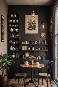 a dining room table with two chairs next to it and shelves on the wall behind it