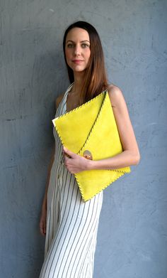 "Soft Symmetria Clutch in yellow. The perfect bag for all occasions! Ideal for cocktail and parties or for business meetings depending the size you choose. It comes in two sizes, small and large. You can use it as a chic briefcase for your work or as a modern large clutch for a night out. This adorable large clutch is handmade out of a genuine, lux Italian yellow suede leather. -Small size fits all your essentials, wallet, keys, mobile, cosmetics etc. -Large size fits a 15\" laptop, ipad, portof Chic Yellow Rectangular Clutch, Chic Yellow Clutch For Daily Use, Chic Yellow Clutch As A Gift, Chic Yellow Clutch As Gift, Chic Yellow Clutch For Gift, Yellow Rectangular Clutch For Everyday Use, Yellow Pouch Clutch, Yellow Leather Clutch For Everyday Use, Chic Yellow Clutch For Everyday Use