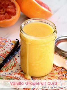 a jar filled with liquid sitting on top of a table next to grapefruit