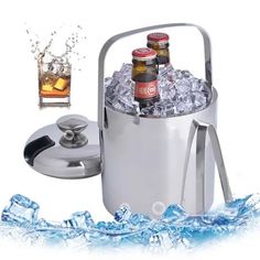 an ice bucket with two bottles in it next to some ice and a drink holder