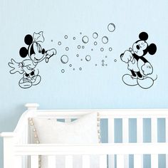 mickey and minnie mouse wall decals in a baby's room