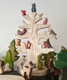 a wooden tree with animals and birds on it