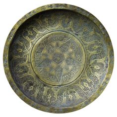 a decorative metal bowl with an intricate design