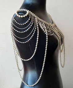 a mannequin with pearls and chains on it