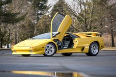 a yellow sports car with its doors open