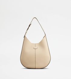 The timeless elegance of the Di Bag style is declined in a hobo version with sober and essential lines. Crafted in calfskin leather, it comes with an adjustable shoulder handle and the characteristic Tod's logo stamped on the front. Complemented by a removable internal pouch, it accompanies your everyday outfits with class and femininity. Luxury Versatile Beige Hobo Bag, Classic Leather-lined Hobo Bag For On-the-go, Beige Tote Hobo Bag With Gold-tone Hardware, Beige Leather-lined Hobo Shoulder Bag, Tods Timeless Bag, Hobo Bags, Bag Style, Logo Stamp, Hobo Bag