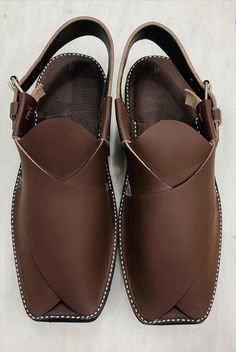 *Elevate your style with our exquisite Dark Brown handmade leather Peshawari shoes. Crafted with precision and care, this footwear is a testament to fine craftsmanship. Handmade from genuine, high-quality leather, this Peshawari footwear offer a perfect blend of comfort and elegance. *The deep, rich brown hue adds a touch of sophistication to any outfit, making them versatile for both casual and formal occasions. Each pair is created with attention to detail, ensuring durability and longevity. T Traditional Formal Leather Shoes With Rubber Sole, Traditional Closed Toe Sandals With Leather Lining, Traditional Closed Toe Leather Sandals, Leather Sandals With Dabka And Round Toe, Traditional Plain Toe Leather Shoes, Artisan Closed Toe Leather Shoes, Artisan Leather Closed Toe Shoes, Traditional Brown Leather Shoes With Stitched Sole, Traditional Brown Leather Shoes With Rubber Sole