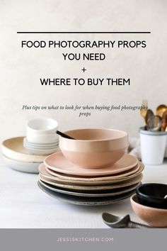 a table topped with plates and bowls filled with food next to utensils on top of each other