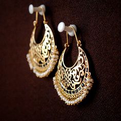 "Intricate filigree in a crescent moon frame, adorned by gorgeous blue stones and finished by tiny dangling pearls, these gorgeous earrings are the only accessory you will need! ) * Gold - 14k, 13.5 gms yellow gold * Style - Hoop * Gems - Blue crystal and pearls * Dimension - 2.2\" x 1.5\" (approx.) Chandelier - Gold Hoop Earring - Chand Bali - Big Wedding Earring If you like these earrings, please press \"Pin it\" button on the right of your screen. Find us on Instagram for exquisite designs: @ Moon Frame, Pin It Button, Chand Bali, Chandelier Gold, Wedding Earring, Chandbali Earrings, Blue Stones, Gold Chandelier, Big Wedding