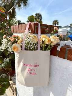 Join The Sunhoney Girls Club with our newest tote bag! This tote features classic canvas material, pink straps, gusset bottom and hold all the essentials and more! Pairs perfectly with any outfit and perfect for those days when you're on the go! 100% Cotton *Product is Made To Order - ships in 3-4 business days* All accessories are final sale. Pink Canvas Weekend Bag, Canvas Bag For Weekend In Spring, Canvas Bag For Weekend In Summer, Canvas Bags For Spring Weekend, Canvas Bag For Weekend And Spring Season, Pink Canvas Bag For Summer, Summer Pink Cotton Shoulder Bag, Pink Cotton Shoulder Bag For Summer, Trendy Pink Cotton Canvas Bag