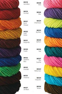 several skeins of yarn are stacked on top of each other in different colors