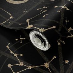 a black and gold wallpaper with stars and circles on it's surface,