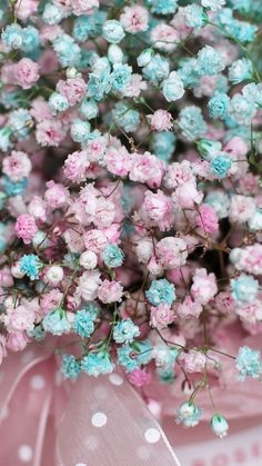 pink and blue flowers are in a vase