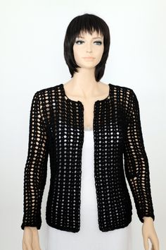 a female mannequin wearing a black jacket and white dress with an open front