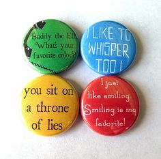 four buttons with different sayings on them