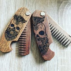 two wooden combs with designs on them and one has a skull in the middle