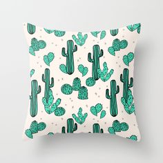 a pillow with green cactus print on it