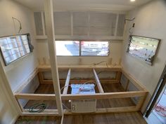 the inside of a mobile home with wood flooring and electrical equipment in place for installation