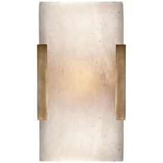 a white and gold wall light against a white background