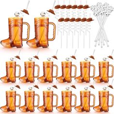 a set of six beer mugs with spoons and forks in them, all filled with caramel colored liquid